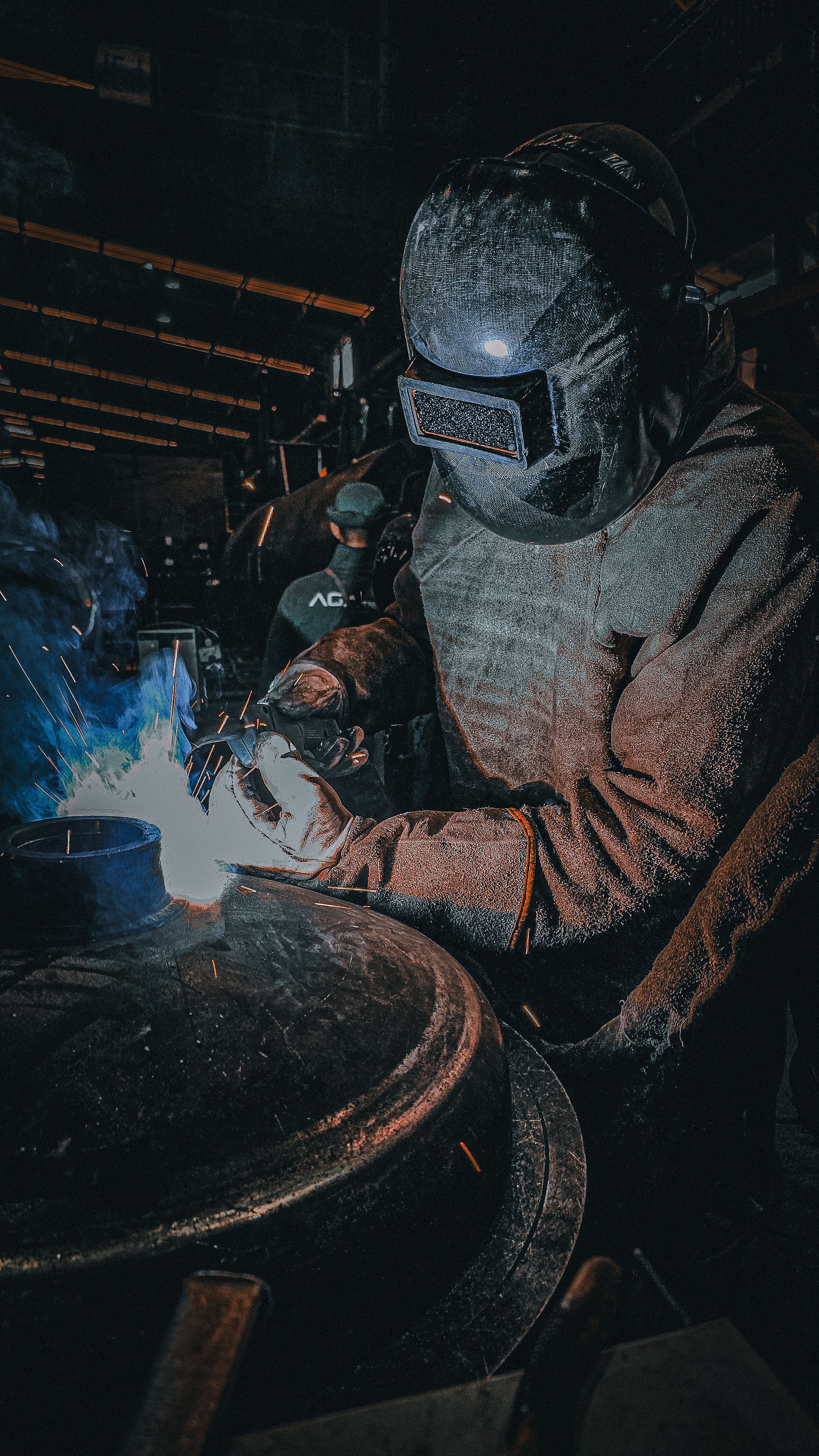 Welding technician working on metal fabrication project