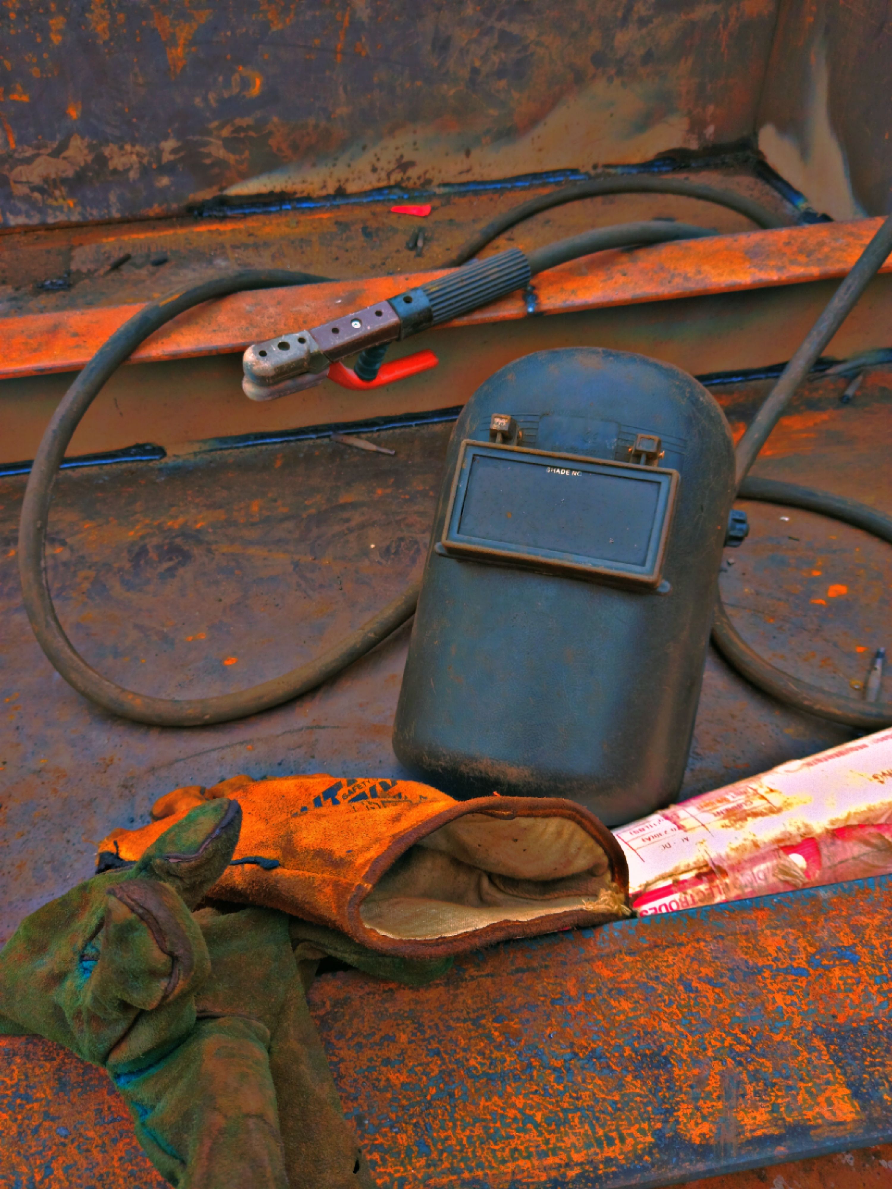Welder performing MIG welding on metal workpiece