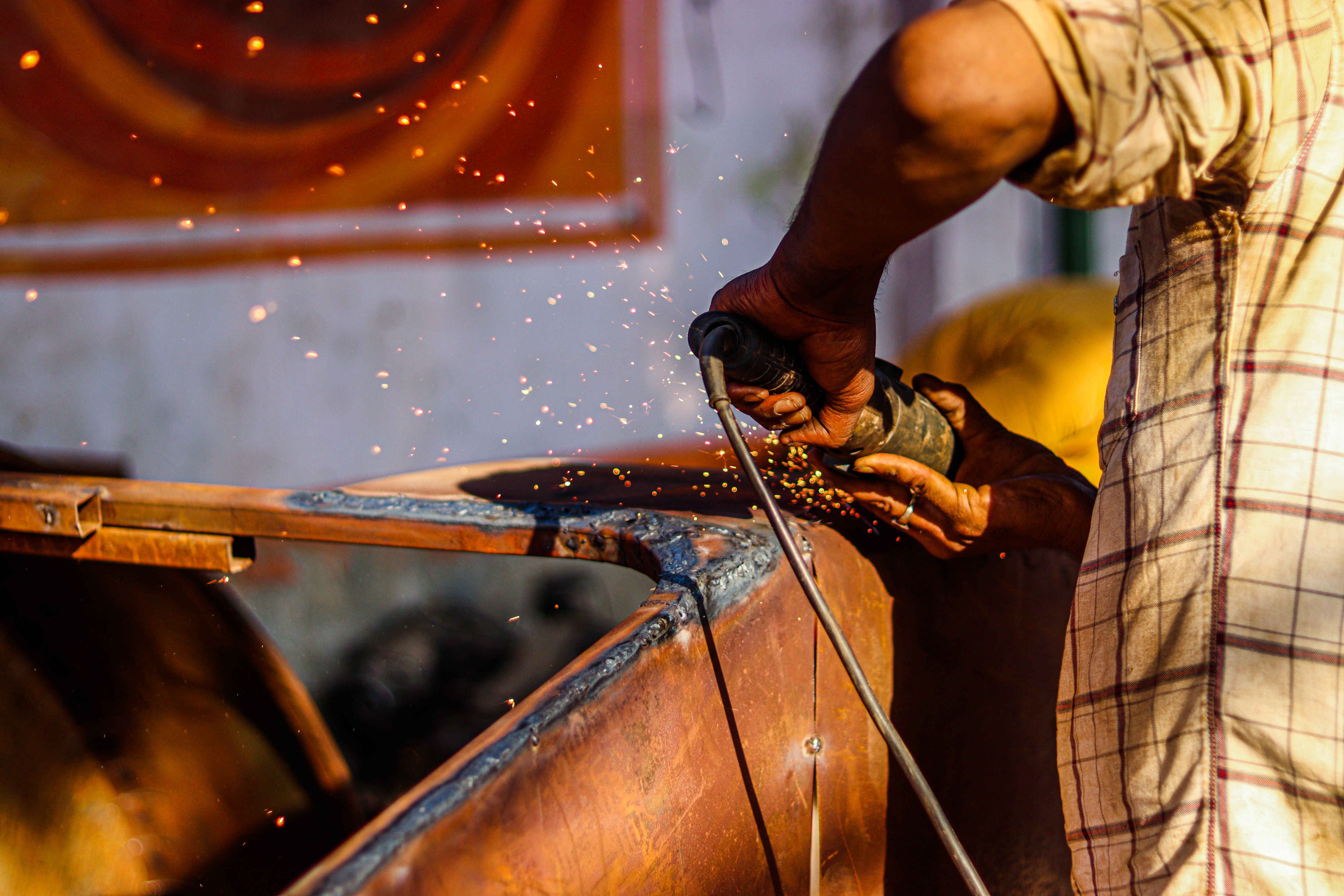 Industrial welding work being performed on metal structures